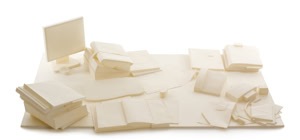 Precise three-dimensional paper reconstruction of a workspace by Herbert Stattler, showing desk objects as monochromatic white paper models based on original pencil drawings.