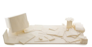 Precise three-dimensional paper reconstruction of a workspace by Herbert Stattler, showing desk objects as monochromatic white paper models based on original pencil drawings.